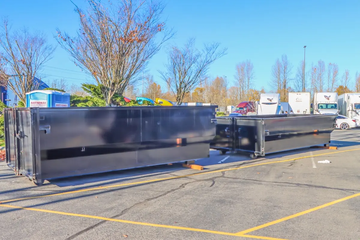 Professional dumpster rental service with roll-off container on residential driveway in Wilmore